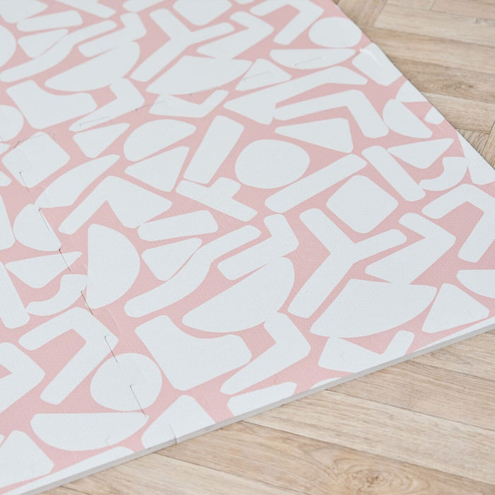 Close-up detail of the print on the Oddity Blush Baby Infinity Playmat.