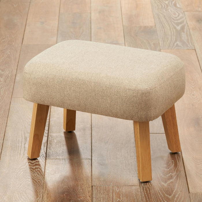 Footstool of the Jonah rocking chair placed on a wooden floor, showing the matching design and finish.