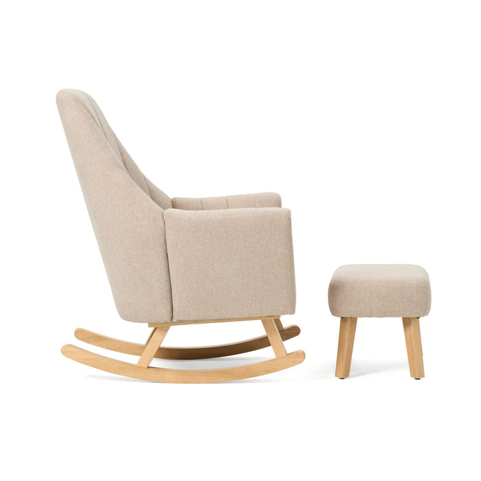 Side view of the Jonah rocking chair and footstool in Stone, showcasing the ergonomic seat angle, high armrests, and supportive footstool for optimal relaxation.