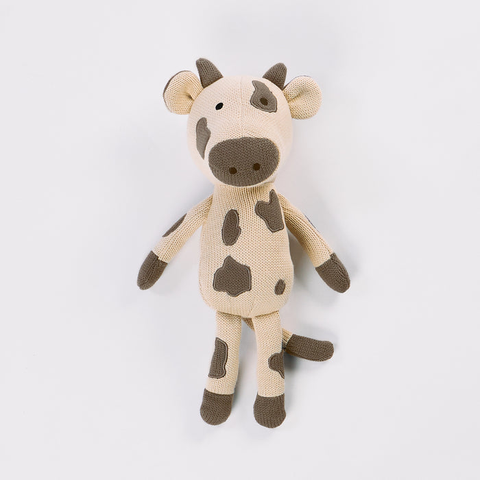 Knitted cow toy on a white background