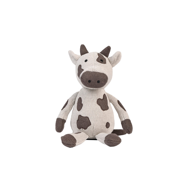 Plush Clemi cow toy sitting on a white background.