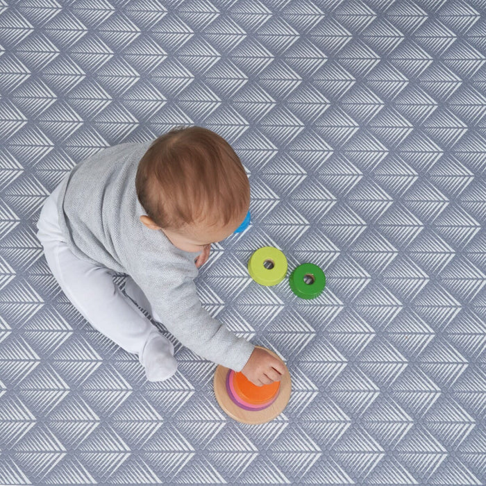 Close-up of a baby playing on the Luxury Padded XL Play Mat in fan, showing the cushioned surface and detailed geometric pattern