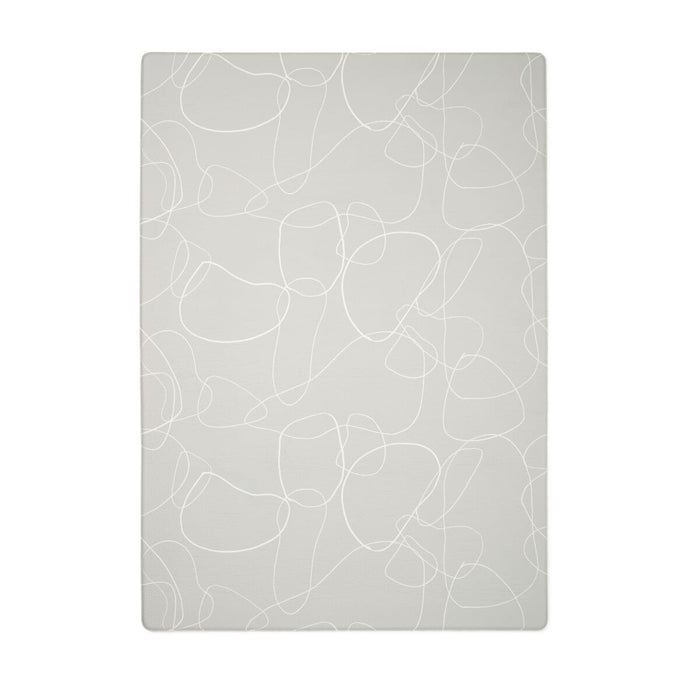 Cutout of the Bubble play mat in soft grey with a white abstract line pattern, showing its smooth, cushioned surface