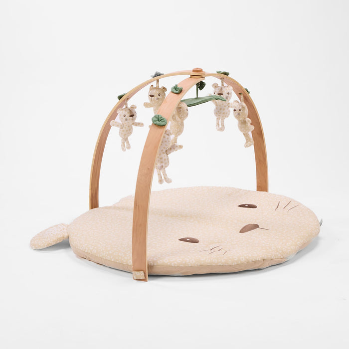 Angled view of Love Cats luxury wood muslin play gym with hanging character toys and soft padded mat.