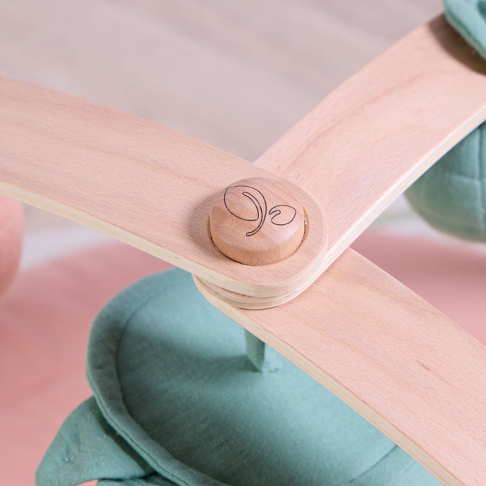 Close-up of natural wooden playgym arch joint with engraved logo and smooth curved beechwood finish.