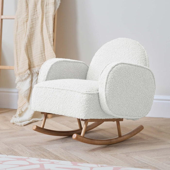 Angled lifestyle view of the Micah Mini Me Rocking Chair in Fresh Cream on timber flooring, featuring ergonomic design and stability for safe rocking.