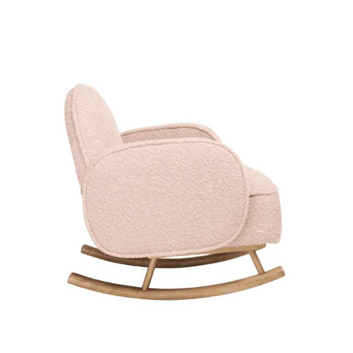 Side view of Micah Mini Me Rocking Chair in blush boucle with wooden rocking base for gentle motion.