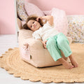 Toddler relaxing on the Milo Mouse beanbag chair in beige, showing comfortable seat shape and soft gingham details in a cosy room setting