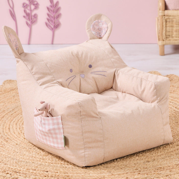 Image showcasing the Milo mouse beanbag chair in beige with pink details, featuring a side pocket, placed on a rug.
