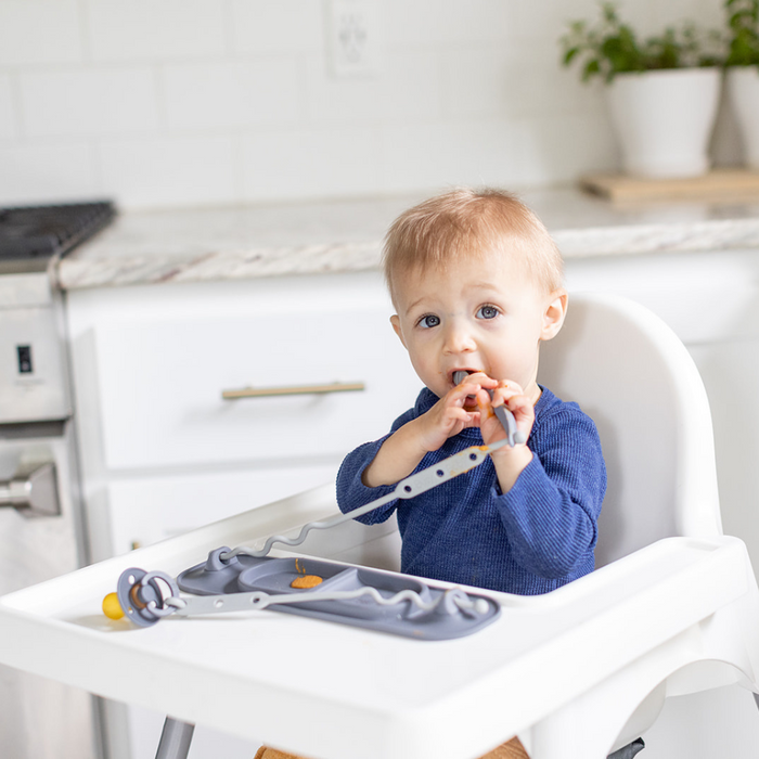 baby sitting in highchair with mini mat suctioned to tray