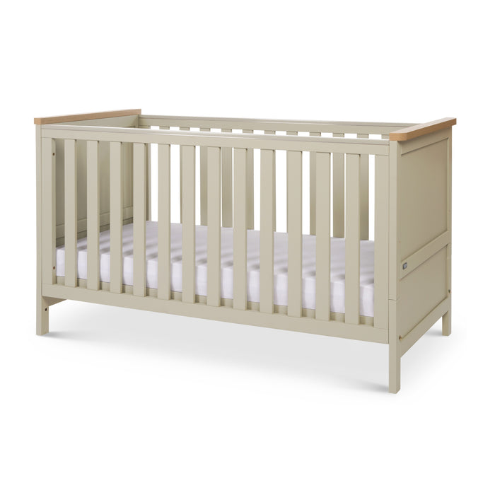 Angle view of the Misha Cot Bed in Mushroom in a white background