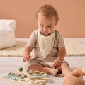 Child playing with wooden toys wearing the Love Cats bandana