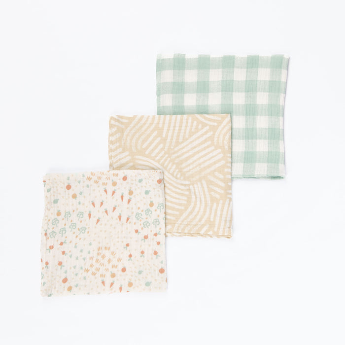 Good Life muslin cloth set laid flat in three coordinating prints, displayed in cutout view to showcase pattern detail and generous size.