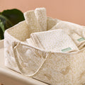 Love Cats nappy caddy in beige leopard print filled with neatly folded muslins, showcasing soft fabric and elegant nursery styling