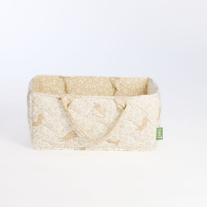 Side view of the Love Cats nappy caddy in beige leopard print, showing quilted design, structured shape, and padded carry handles