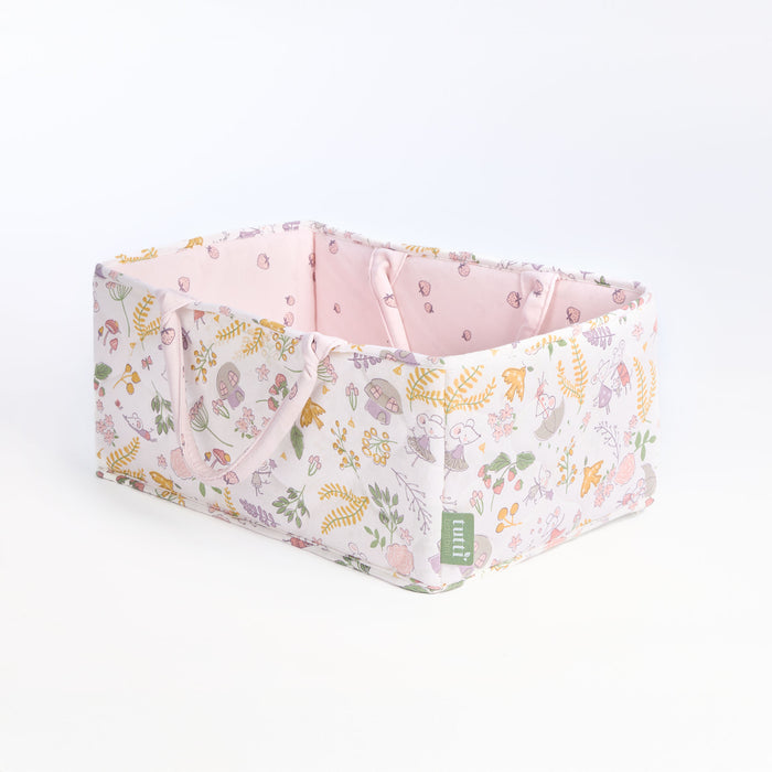 Angled cutout of the Tiny Tails nappy caddy in pink floral woodland print, highlighting quilted detail and spacious storage design