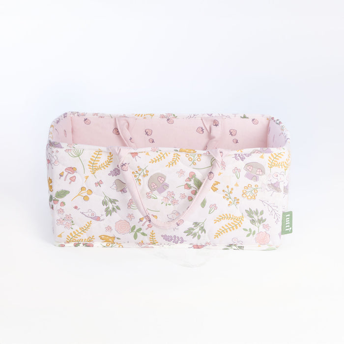 Side view of the Tiny Tails nappy caddy in pink woodland pattern, featuring soft padded handles and coordinating blush interior