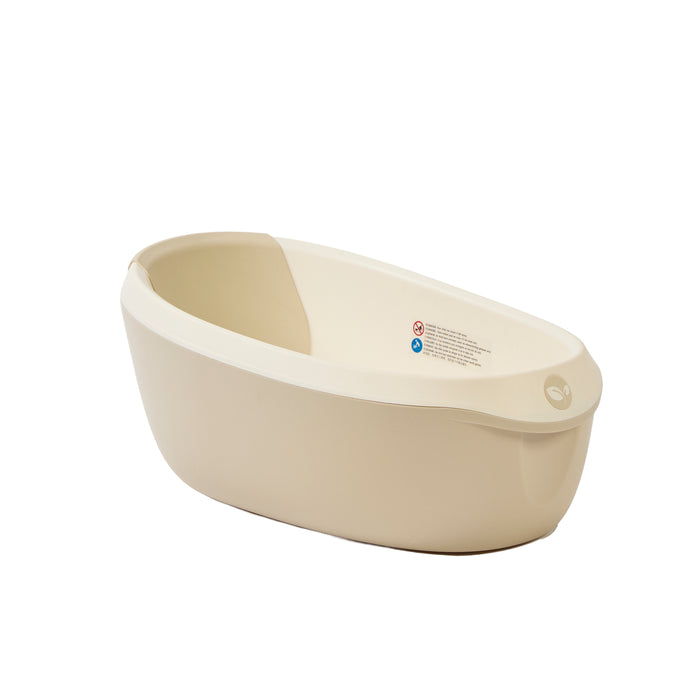 Angled front view of the Nati Baby Bath in dune with clean curved lines and a calming neutral finish for modern bathrooms.