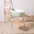 Nati Baby Bath in aloe on wooden stand bringing soft colour and practicality to bath time.