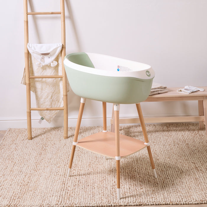 Nati Baby Bath in aloe on wooden stand bringing soft colour and practicality to bath time.