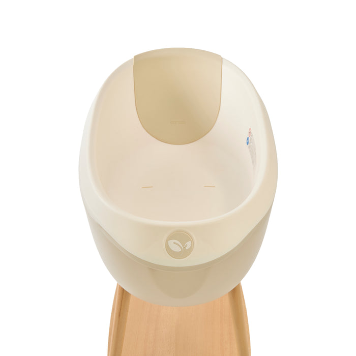 Inside view of the Nati Baby Bath in Dune, placed on its wooden stand against a clean white background. A minimal product image highlighting the bath’s design, shape, and premium details.