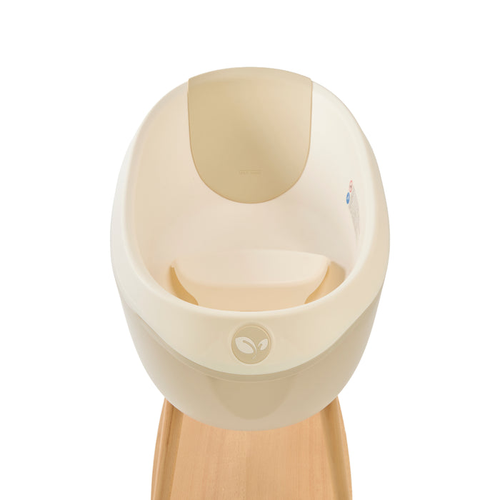 Inside view of the Nati Baby Bath in Dune, placed on its wooden stand against a clean white background. A minimal product image highlighting the bath’s design, shape, and premium details.