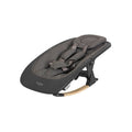 Angled side view of the Nova rocker in Grey and Oak with padded seat insert, harness, and gentle curved legs for soothing motion.