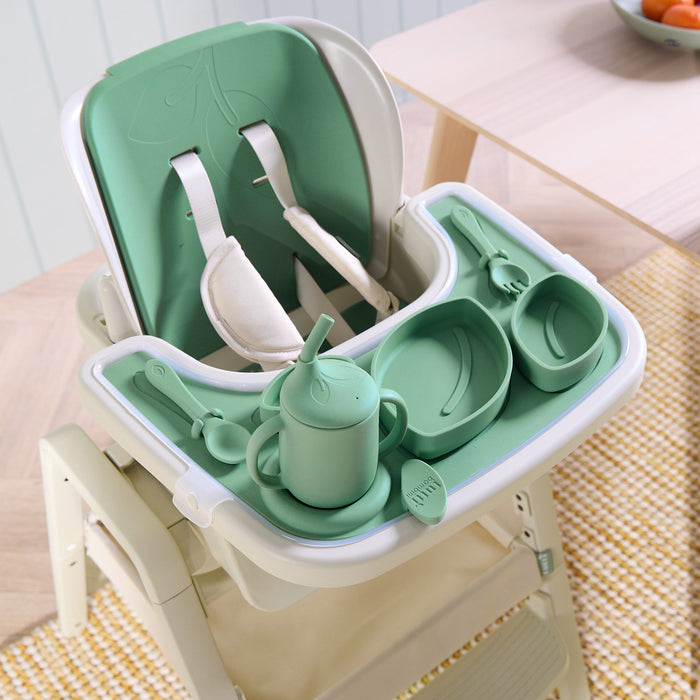 Nova Maison highchair and accessory pack in green and white on a wooden floor.