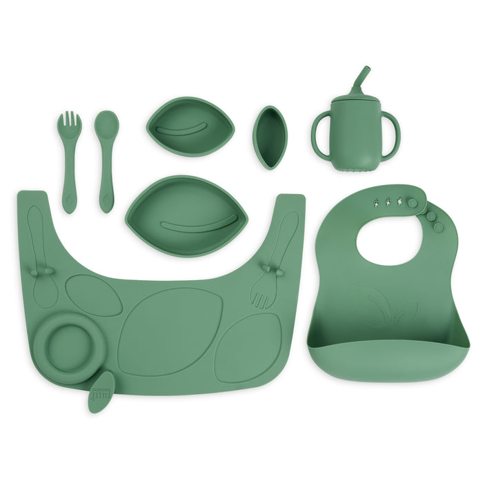 Green silicone baby set including bib, plate, cup, and utensils on a white background