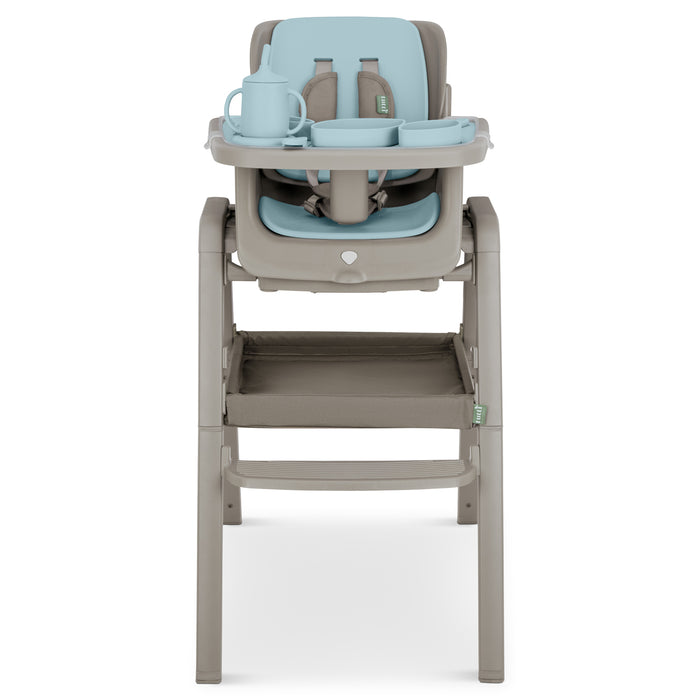 Front cutout view of Nova highchair in harbour and truffle featuring five-point harness and coordinated silicone feeding set on tray.