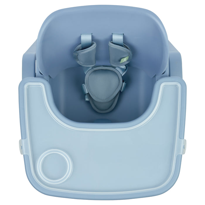 Top-down view of the nova maison 7 in 1 highchair in coast, highlighting contoured seat, padded harness and removable feeding tray.