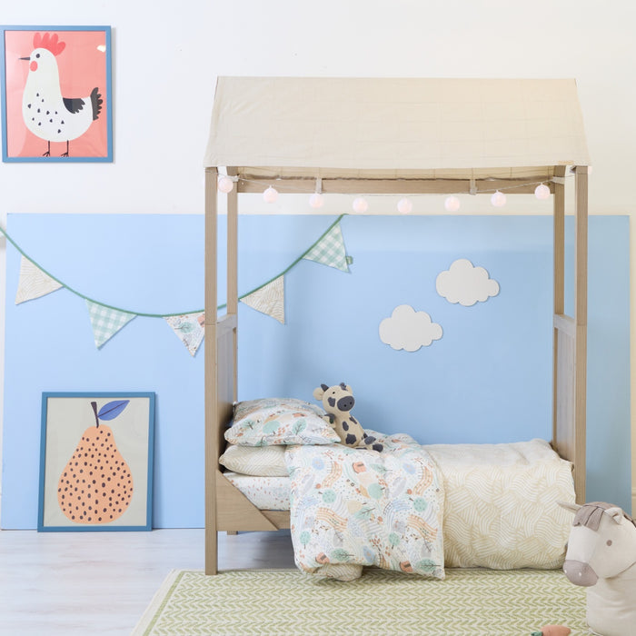 Good life nursery bunting framed with pear artwork and soft toy accents in a blue nursery.