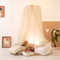 Children's play area with a canopy, teddy bear, and decorative elements in a cosy room.