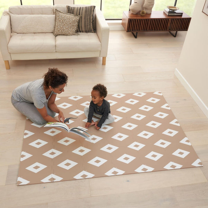 Lifestyle view of the diamond cinnamon puzzle playmat, with parent and child reading together on the cushioned play surface