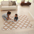 Lifestyle view of the diamond cinnamon puzzle playmat, with parent and child reading together on the cushioned play surface