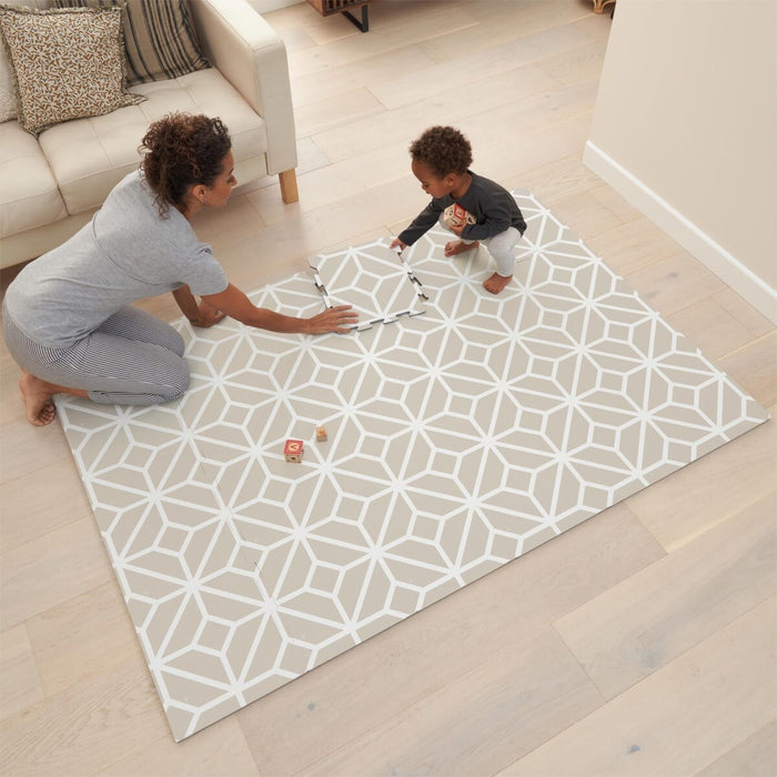 Lifestyle scene showing parent and child playing on the tiles white sand puzzle playmat, offering cushioned comfort for floor play