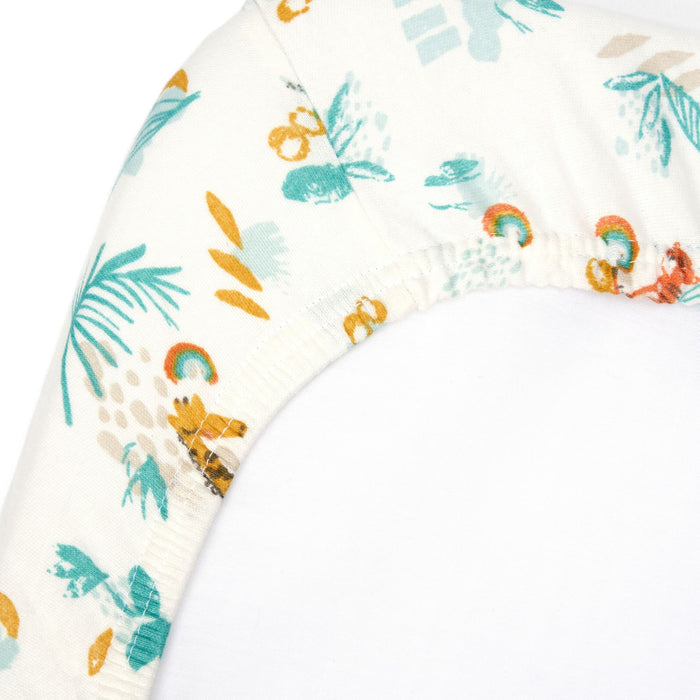 Corner close-up of Run Wild bedside crib sheet in organic cotton, showing elasticated edge and vibrant safari animal print detail