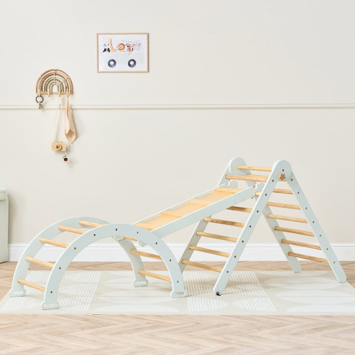 Styled room view of the Scala Montessori Pikler climbing frame in sea mist, blending natural wood tones with calm pastel play design