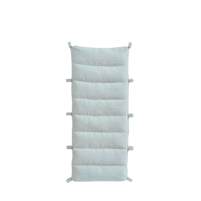 Cutout view of the Scala Pikler cushion in boucle sea mist finish, featuring plush quilting and fabric loops for easy attachment