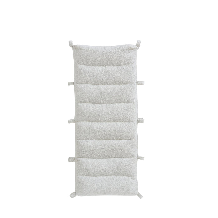 Cutout view of the Scala Montessori Pikler cushion in boucle natural with multiple fabric ties for secure attachment.