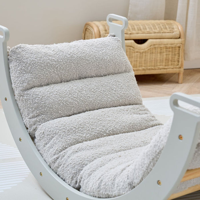 Close-up view of the Scala Montessori Pikler Cushion in Boucle Mushroom attached to frame, showing soft padding and warm neutral tones