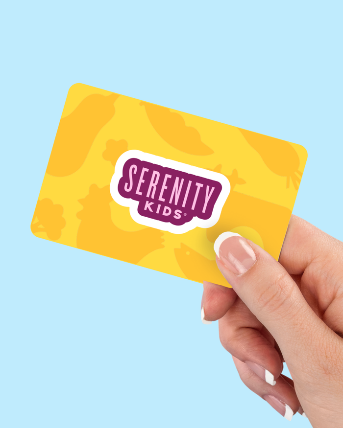 Hand holding a yellow 'Serenity Kids' card against a light blue background