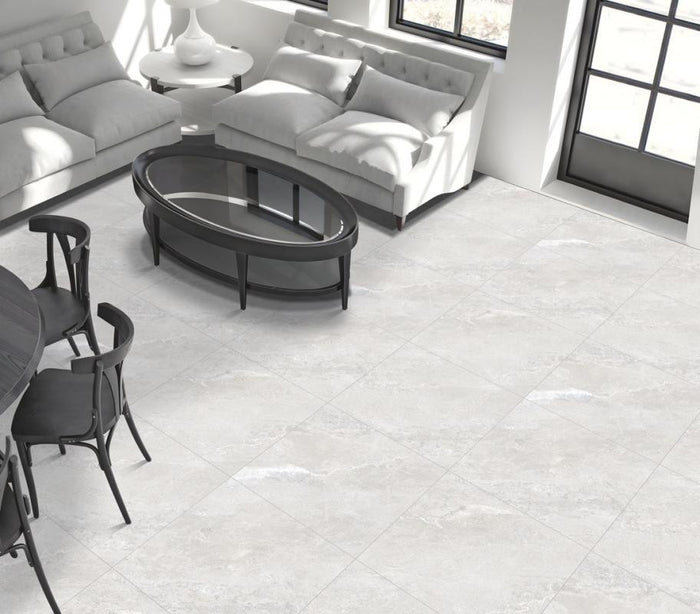 Living room with white tiled floor, gray sofa, and black coffee table.