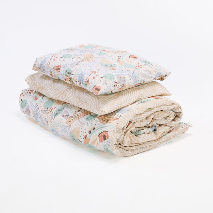 Cutout of the Good Life duvet cover and pillowcase set showing reversible farmyard and geometric prints in soft, breathable muslin cotton