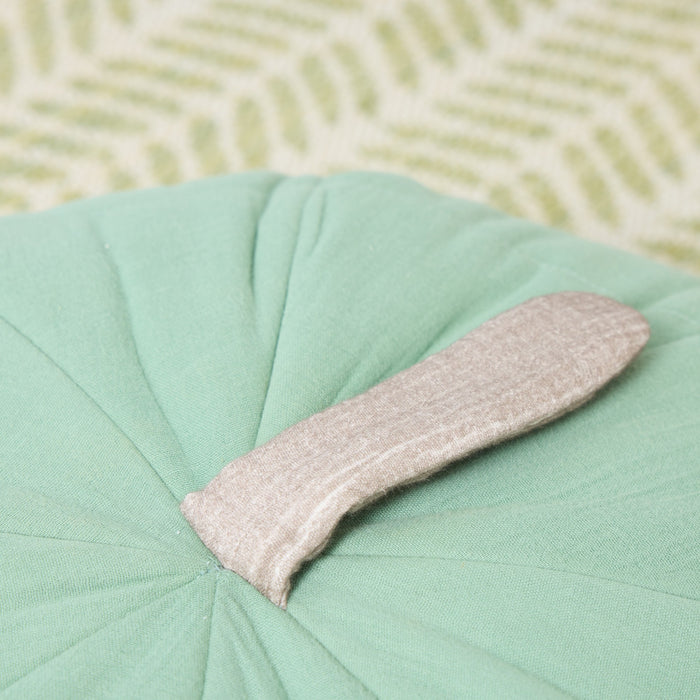 Close-up of the Soft Muslin Apple Cushion highlighting the soft fabric stem and stitched pleating on the smooth rounded top