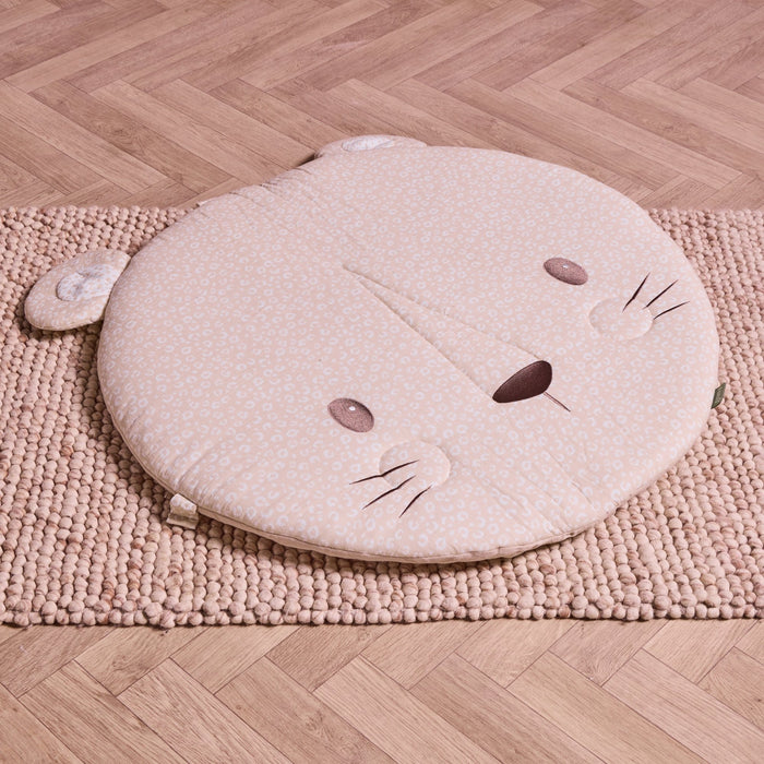 Round Larry Leopard baby playmat in soft beige print with ears and embroidered face, placed on textured rug.