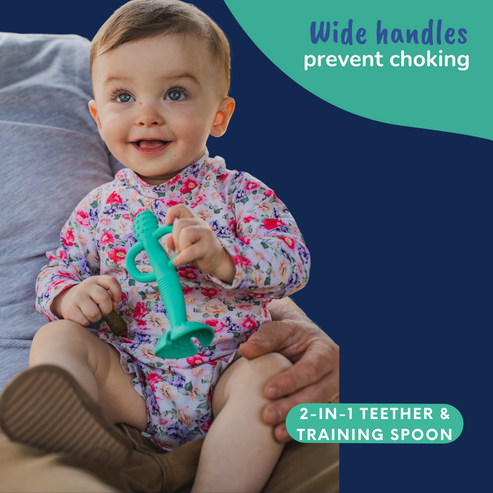 Baby Holding Busy Baby 2-in-1Teether & Training Spoon in color Spearmint