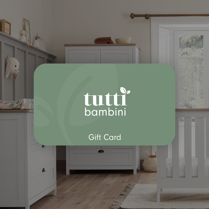 A Tutti Bambini gift card displayed in a nursery room setting.