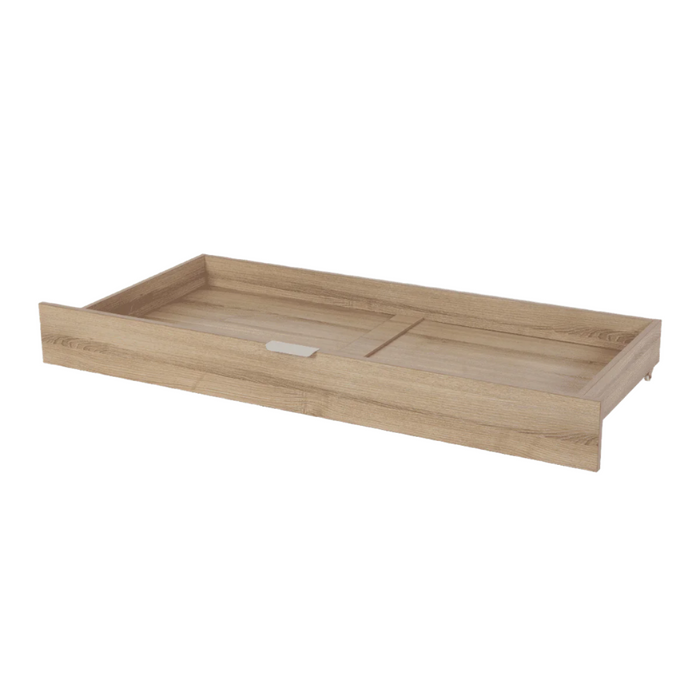 Angled view of the underbed storage drawer in oak, highlighting soft edges, minimalist design and handy front pull tab for access