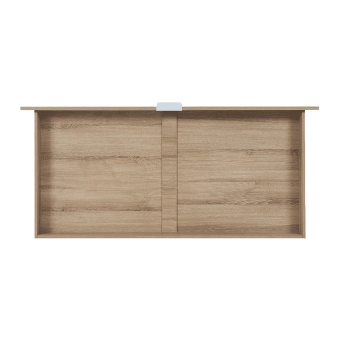 Overhead view of the underbed storage drawer in oak finish, showcasing internal space for baby essentials, bedding or toys